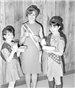 Yamhill Dairy Princess and 2 young girls holding glasses of milk.