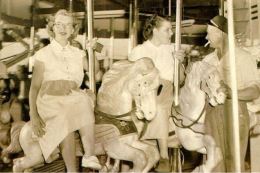 People riding the carousel in 1900.