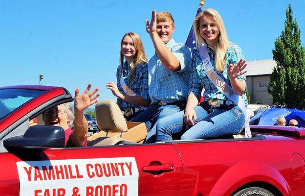Fair Ambassadors sitting in convertible waving
